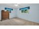 Light-filled bedroom with neutral carpet, ample natural light, and a serene atmosphere at 2113 Malcolm Dr, Palm Harbor, FL 34684