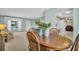 Cozy dining area seamlessly connecting to the living room and kitchen, filled with natural light at 2113 Malcolm Dr, Palm Harbor, FL 34684