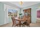 Bright dining room features a wood table and chairs next to a window and hutch at 2113 Malcolm Dr, Palm Harbor, FL 34684