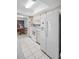 Bright kitchen features a white refrigerator, oven, microwave and tile flooring at 2113 Malcolm Dr, Palm Harbor, FL 34684