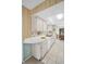 Bright kitchen with a white countertop, cabinets, stainless steel sink and dishwasher at 2113 Malcolm Dr, Palm Harbor, FL 34684