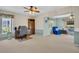 Inviting living room with bright natural light, ceiling fan and adjacent sitting area at 2113 Malcolm Dr, Palm Harbor, FL 34684