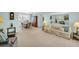 Bright living room with carpet, a large mirror, a dining area and a view of the outdoors at 2113 Malcolm Dr, Palm Harbor, FL 34684