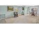 Comfortable living room with cozy armchairs, soft carpeting, and a bright airy atmosphere at 2113 Malcolm Dr, Palm Harbor, FL 34684