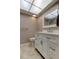 Bathroom featuring a modern vanity with white cabinets, updated fixtures, and neutral tile flooring at 2380 Shelly Dr # B, Palm Harbor, FL 34684