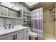 Bathroom features a shower, toilet, vanity with sink and modern fixtures and cabinet for optimal storage at 2380 Shelly Dr # B, Palm Harbor, FL 34684
