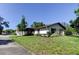 Charming home featuring a well-manicured lawn and mature trees, showcasing its curb appeal at 2380 Shelly Dr # B, Palm Harbor, FL 34684