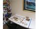 Cozy game room with puzzles and a bookshelf filled with books and games for leisure activities at 2380 Shelly Dr # B, Palm Harbor, FL 34684