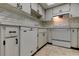 Bright kitchen with white appliances, updated tile backsplash, and ample cabinet space at 2380 Shelly Dr # B, Palm Harbor, FL 34684