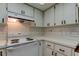 Bright kitchen featuring sleek white appliances, updated tile backsplash and stylish cabinets at 2380 Shelly Dr # B, Palm Harbor, FL 34684