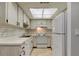 Kitchen with white cabinets, modern appliances, and a bright, well-lit atmosphere at 2380 Shelly Dr # B, Palm Harbor, FL 34684