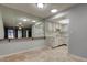 Open-concept layout connecting the dining and kitchen areas, featuring white cabinets and tile floors at 2380 Shelly Dr # B, Palm Harbor, FL 34684