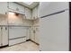 A bright kitchen with white appliances and matching cabinets at 2380 Shelly Dr # B, Palm Harbor, FL 34684