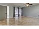 Open living room featuring tiled floors, sliding glass doors, and neutral wall paint at 2380 Shelly Dr # B, Palm Harbor, FL 34684