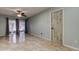 Bright living room featuring tile floors, ceiling fan, and sliding glass doors leading to the outside at 2380 Shelly Dr # B, Palm Harbor, FL 34684