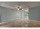 Open living room with tiled floors, ceiling fan, and light blue painted walls at 2380 Shelly Dr # B, Palm Harbor, FL 34684