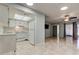Open living space with tile floors, white appliances, and plenty of natural light at 2380 Shelly Dr # B, Palm Harbor, FL 34684