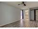 Primary bedroom featuring modern flooring, ceiling fan, and access to a private bathroom at 2380 Shelly Dr # B, Palm Harbor, FL 34684