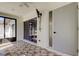 Enclosed sunroom featuring a ceiling fan, tile flooring, and a door to the exterior at 2380 Shelly Dr # B, Palm Harbor, FL 34684