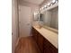 Bathroom with laminate floors, vanity with countertop sink, and modern lighting at 2406 Cypress Pond Rd # 2406, Palm Harbor, FL 34683