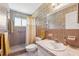 Bathroom featuring floral wallpaper, tile shower with glass enclosure, and a white sink at 2461 Rhodesian Dr # 37, Clearwater, FL 33763