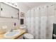 Bathroom with a white sink, toilet, patterned shower curtain and tile flooring at 2461 Rhodesian Dr # 37, Clearwater, FL 33763