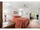 Bedroom featuring hard wood floors, ceiling fan and view of an adjacent sitting room at 2461 Rhodesian Dr # 37, Clearwater, FL 33763