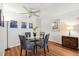 Dining area with a glass table, wood floors, and modern decor; bright and inviting space for meals at 2461 Rhodesian Dr # 37, Clearwater, FL 33763