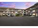 Multi-story condo building featuring brick accents, balconies, well-maintained landscaping, and ample parking at 2461 Rhodesian Dr # 37, Clearwater, FL 33763