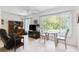 Living room featuring a television, dining area with fan and view of the backyard at 2461 Rhodesian Dr # 37, Clearwater, FL 33763