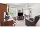 Living room featuring a television, dining area with fan and view of the backyard at 2461 Rhodesian Dr # 37, Clearwater, FL 33763