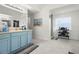 Bathroom with blue vanity and a walk-in shower with frosted windows at 2832 Brinley Dr, Trinity, FL 34655