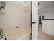 Bathroom featuring a white-tiled shower and a partial view of the vanity at 2832 Brinley Dr, Trinity, FL 34655