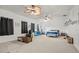 Large bedroom with a ceiling fan, dark curtains, and a variety of seating at 2832 Brinley Dr, Trinity, FL 34655