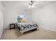 Bright bedroom with a window, ceiling fan, and simple furnishings at 2832 Brinley Dr, Trinity, FL 34655