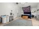 Spacious bedroom featuring a decorative rug, desk, and unique wall tapestry at 2832 Brinley Dr, Trinity, FL 34655