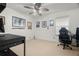 Neutral bedroom with a fan, window with blinds, gaming chair, and decor at 2832 Brinley Dr, Trinity, FL 34655