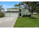 Home exterior with a manicured front yard and an attached three-car garage at 2832 Brinley Dr, Trinity, FL 34655