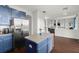Kitchen with blue cabinets, stainless steel refrigerator, and an island with breakfast bar at 2832 Brinley Dr, Trinity, FL 34655