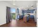 Bright kitchen with blue cabinets, stainless steel appliances, and a large sliding door to the outside at 2832 Brinley Dr, Trinity, FL 34655