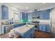 Kitchen with island, blue cabinets, and stainless steel appliances at 2832 Brinley Dr, Trinity, FL 34655