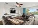Spacious living room with a leather sofa, TV, and access to the outdoors at 2832 Brinley Dr, Trinity, FL 34655