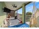 Cozy screened-in patio featuring a ceiling fan, hammock, and views of the lush landscape for relaxing outdoors at 2832 Brinley Dr, Trinity, FL 34655
