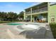 Inviting backyard pool and spa with ample patio space for entertaining or relaxing on a sunny day at 2832 Brinley Dr, Trinity, FL 34655