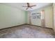 Bedroom features a large window, fan, carpeted floor, and good natural lighting at 309 Kenmore Rd, Brandon, FL 33511