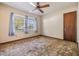 Bright bedroom with a ceiling fan, window with curtains, and standard closet with an inviting cozy feel at 309 Kenmore Rd, Brandon, FL 33511