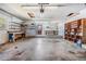 Spacious garage with storage shelves, workbench, and door leading to the outside at 309 Kenmore Rd, Brandon, FL 33511