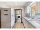 Kitchen with white cabinets, tile floors, and appliances, plus a view into the laundry room at 309 Kenmore Rd, Brandon, FL 33511