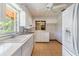 Efficient kitchen with white cabinets and appliances with a view of the front door at 309 Kenmore Rd, Brandon, FL 33511