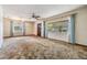 Bright living room with large windows, carpet, and a ceiling fan at 309 Kenmore Rd, Brandon, FL 33511